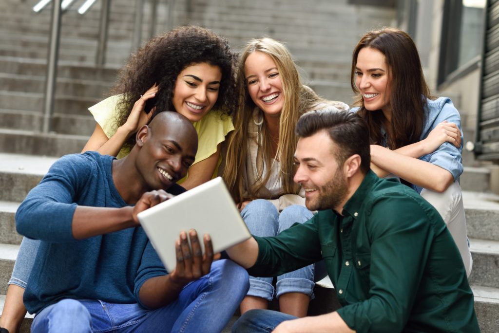 multi-ethnic-group-of-young-people-looking-at-a-tablet-computer